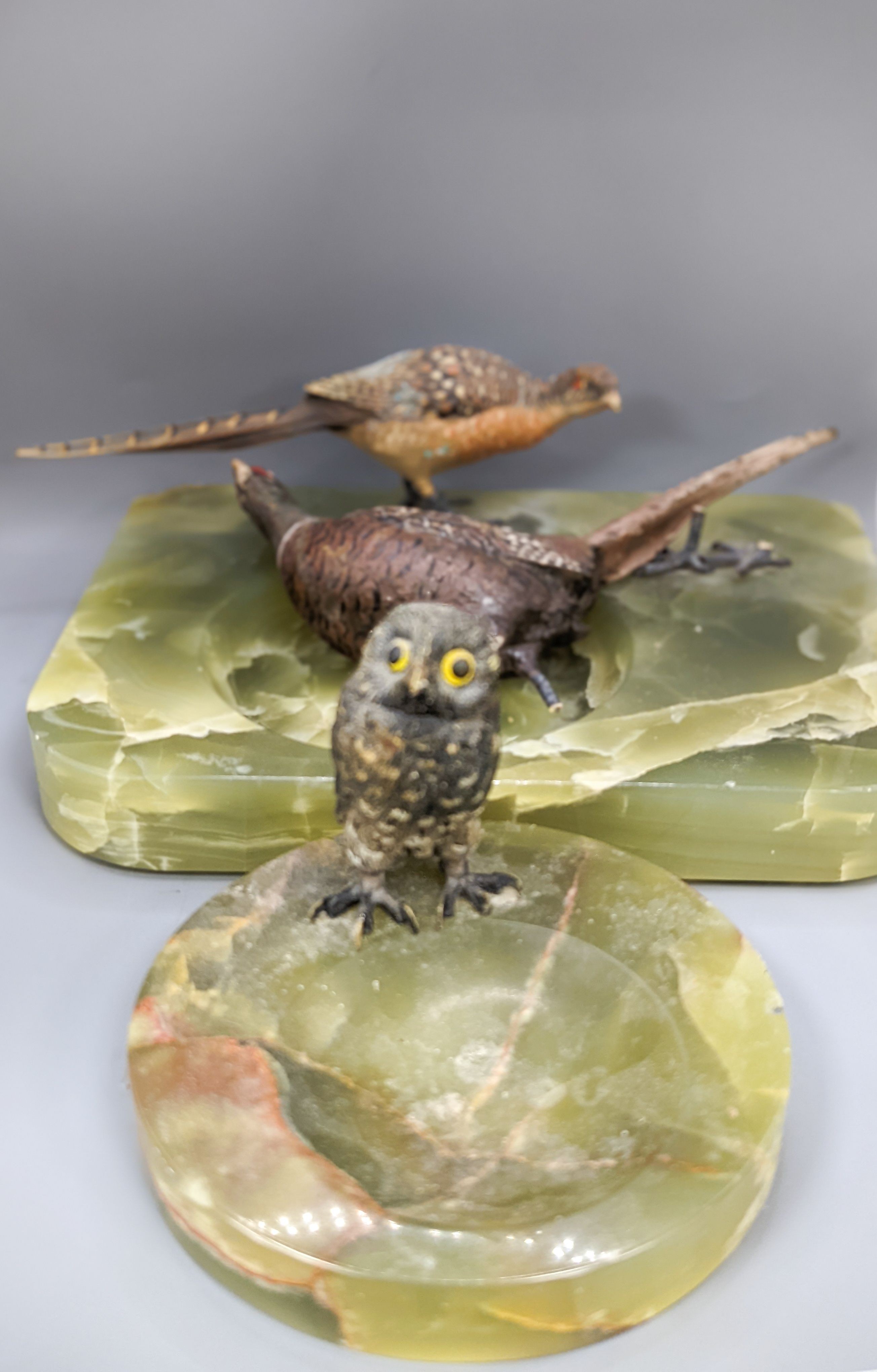 A green onyx ash stand, mounted with cold painted bronze pheasants and another, mounted with a model of an owl (2)